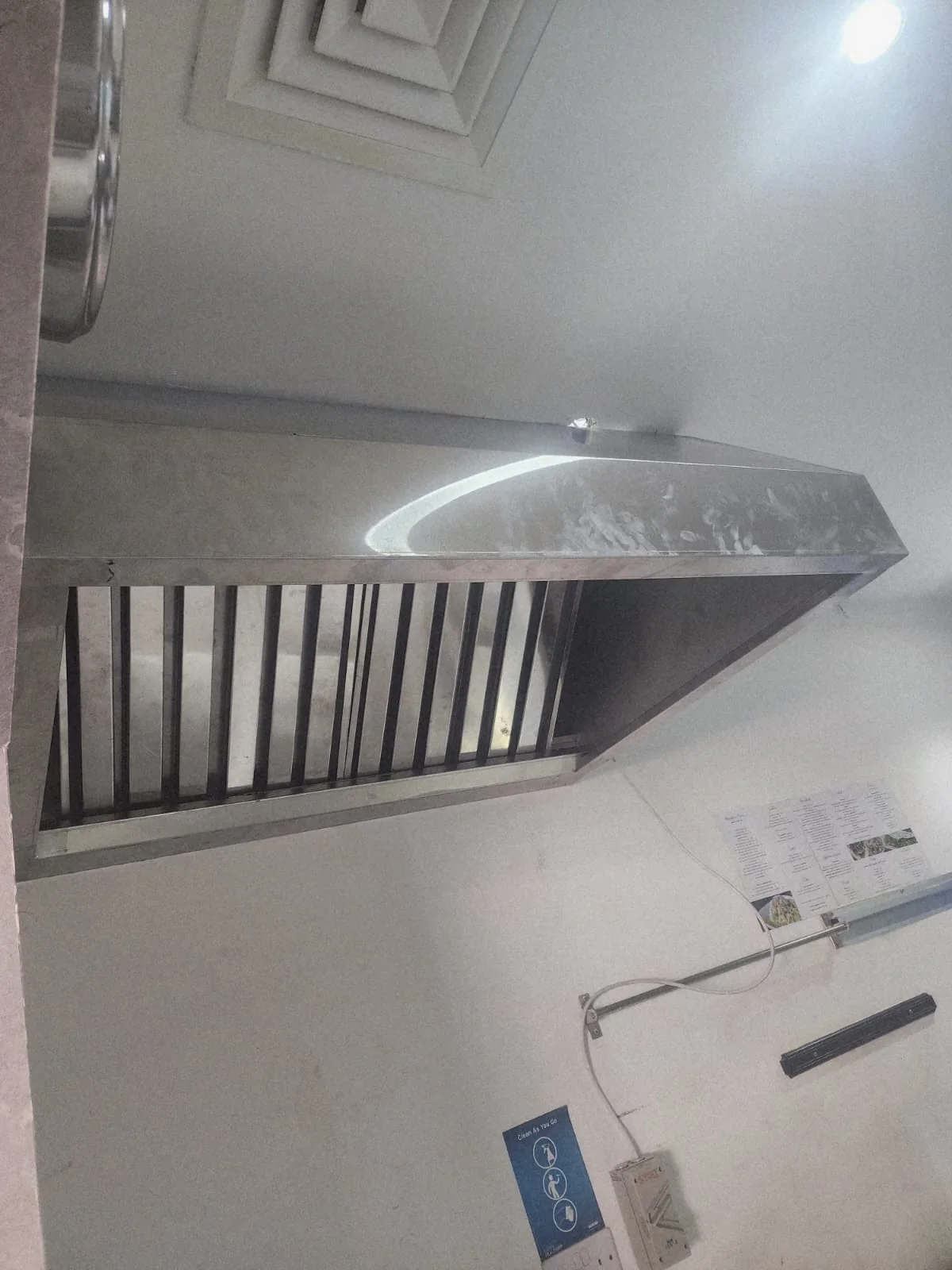 Underside view of an installed commercial kitchen hood and extraction assembly Underside view of an installed commercial kitchen hood and extraction assembly