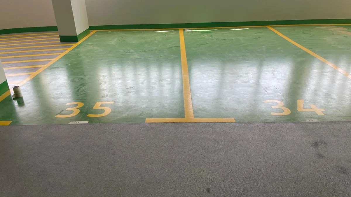 Green epoxy parking bays with numbers and boundary lines