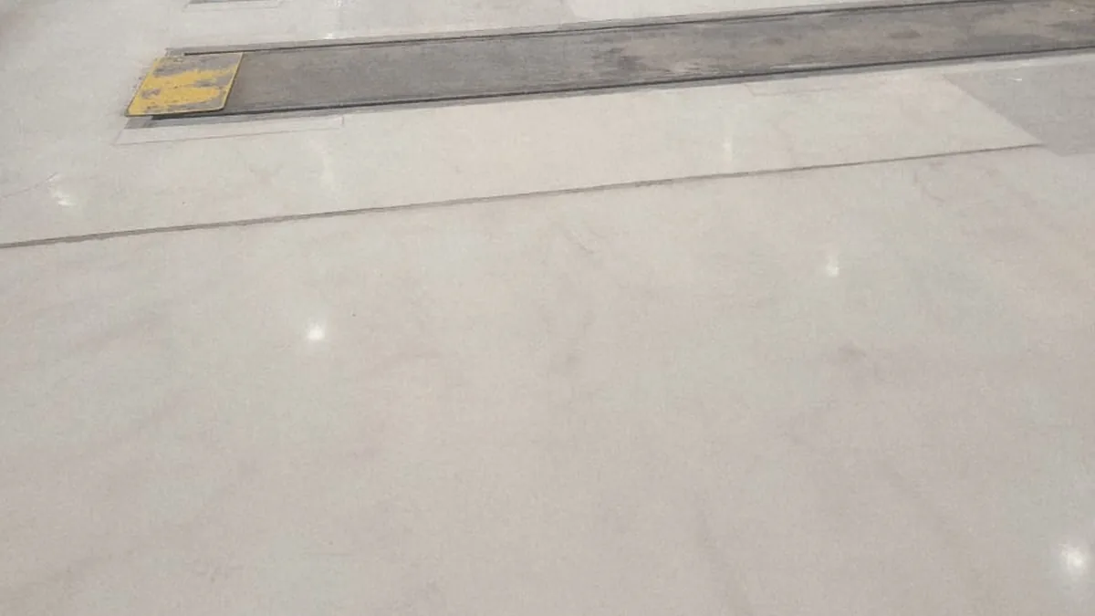 Before - Existing workshop floor condition and completed grey epoxy coated zone
